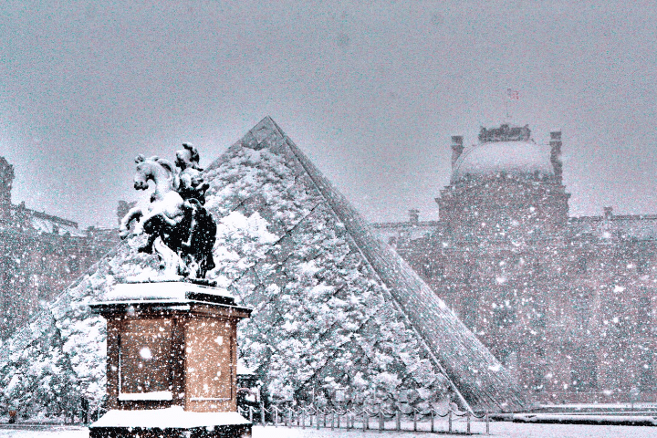 Glass pyramid of the Louvre covered in snow