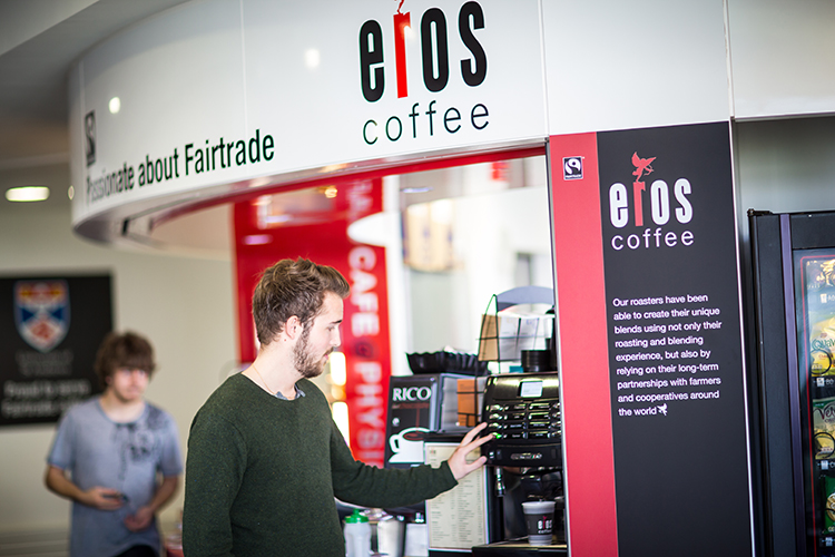 A student using a coffee machine at the Physics cafe