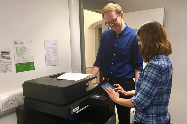 Two people using University printers