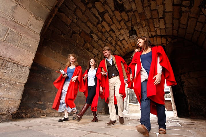 Students walking under the arch to St Salvator's Quadrangle